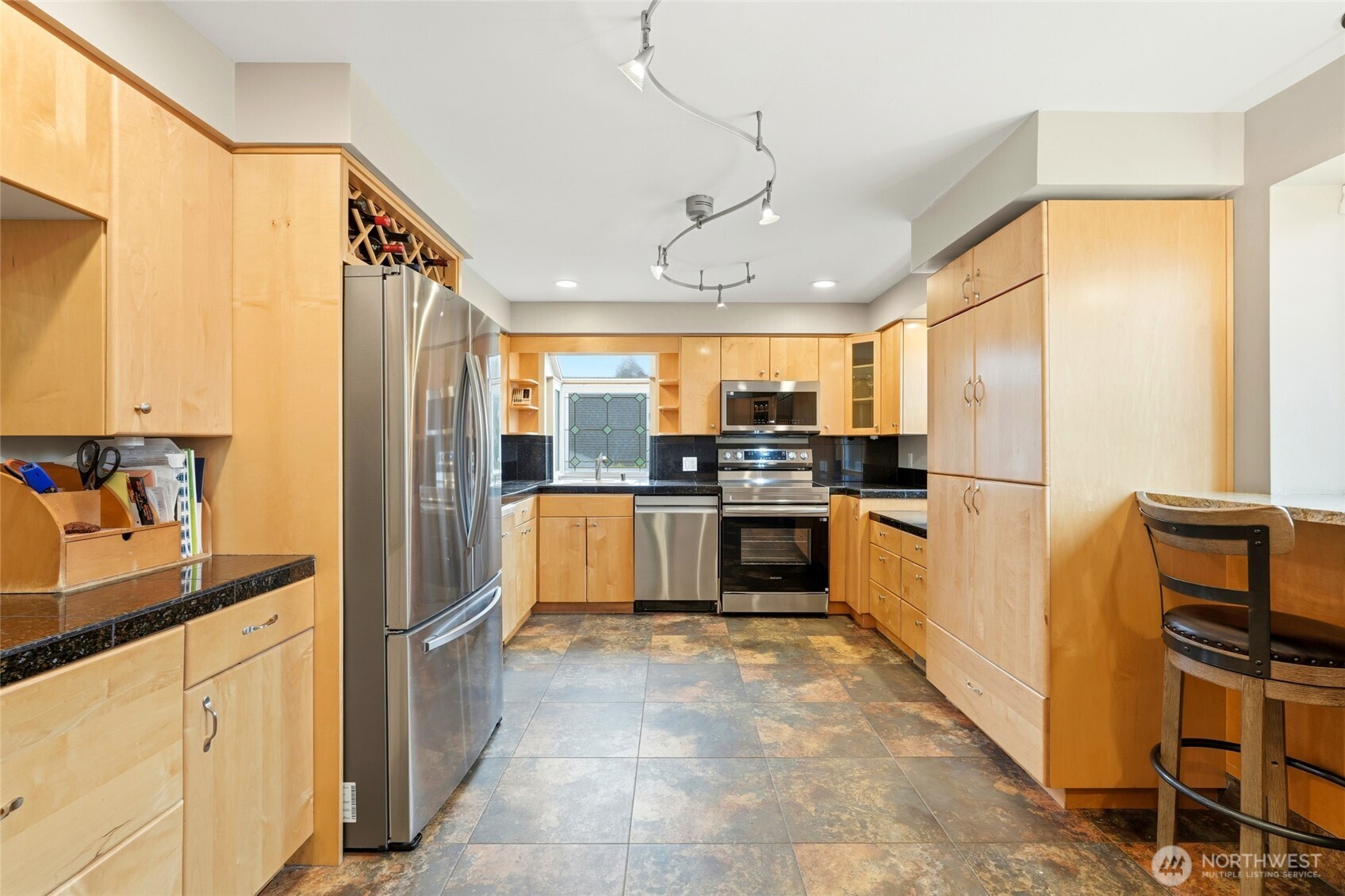 32130 27th Avenue Southwest Federal Way, WA 98023 - Photo 11 of 40 a kitchen with stainless steel appliances a refrigerator and a stove