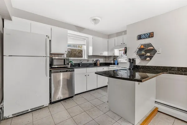 a kitchen with cabinets stainless steel appliances and a sink