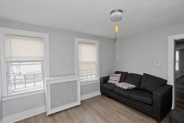 a view of a livingroom with wooden floor and a window