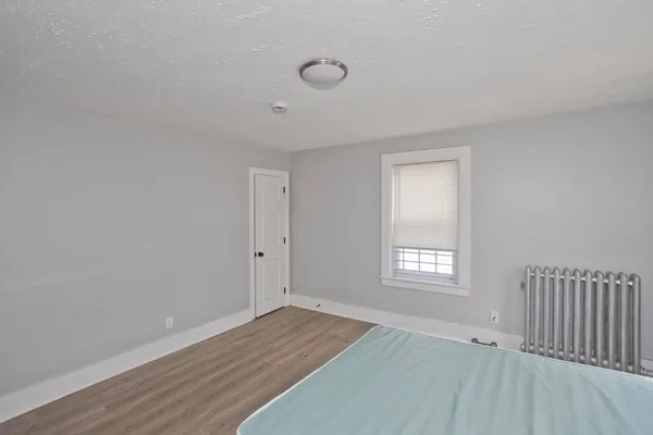 a living room with hard wood floors and window