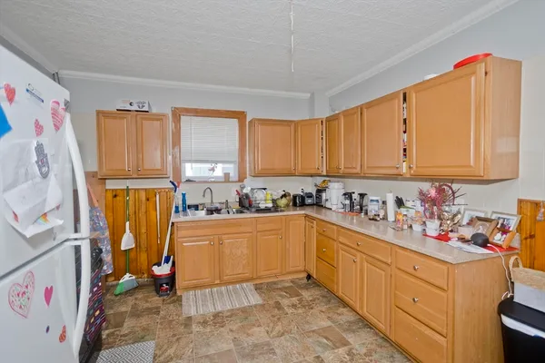 a kitchen with stainless steel appliances a refrigerator and a stove top oven