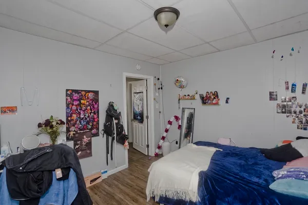 a bedroom with furniture and wooden floor