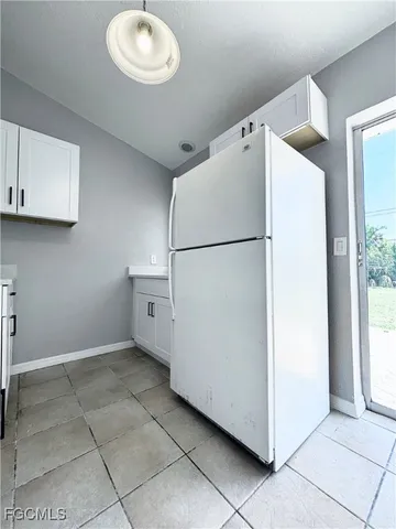 a white refrigerator freezer sitting inside of a kitchen