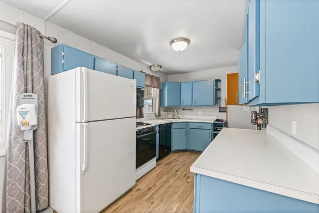 a white refrigerator freezer sitting inside of a kitchen