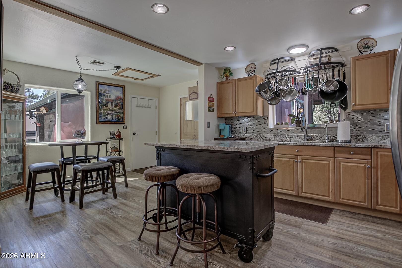 3762 Watertank Road Pine, AZ 85544 - Photo 8 of 38 a kitchen with stainless steel appliances granite countertop a table chairs sink and cabinets