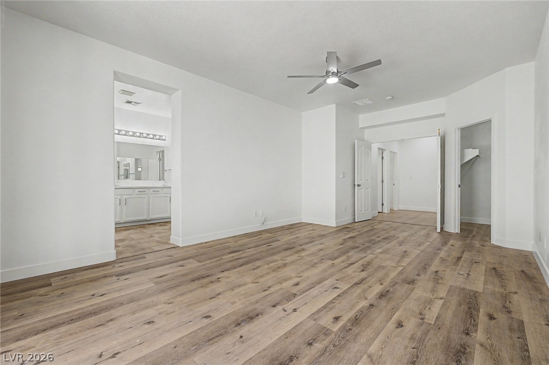 835 Entrada Ridge Avenue Henderson, NV 89012 - Photo 14 of 34 Ample space with rich wood flooring leads to a private bath and convenient closet access.