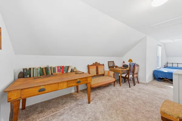 a living room with furniture a rug and a wall painting