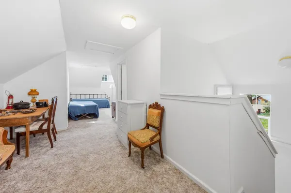 a bed sitting in a bedroom next to a window