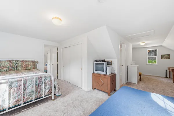 a bedroom with bed and window