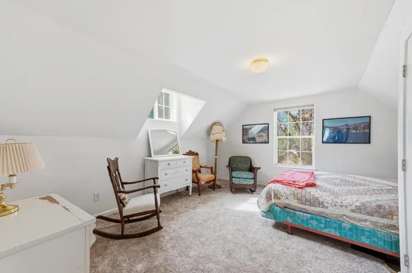 a bedroom with bed and a bookshelf