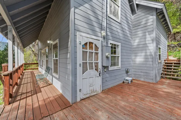 a view of backyard with deck and outdoor seating
