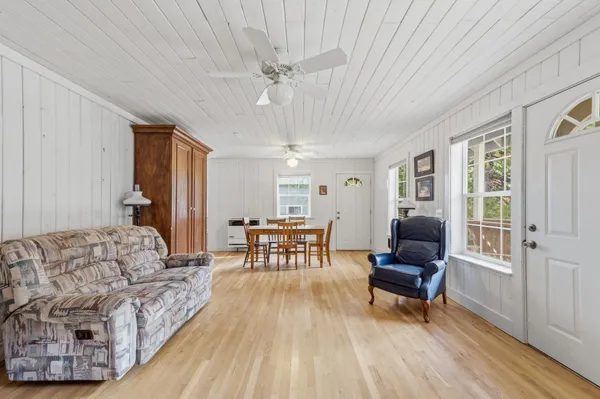 a living room with furniture and a wooden floor