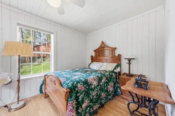 a bed sitting in a bedroom next to a window