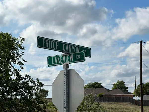 a street sign sitting on a wooden wall