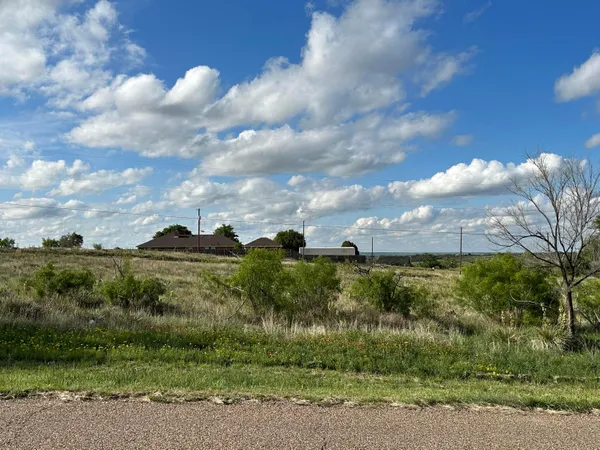 a view of a lake with a yard