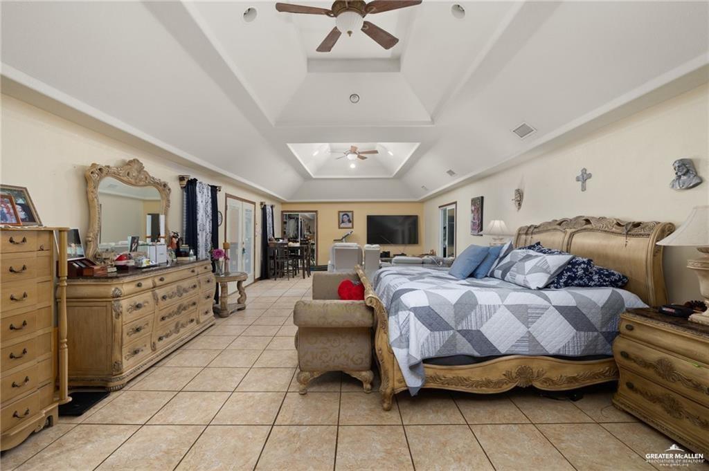 4523 South Tower Road Edinburg, TX 78542 - Photo 19 of 32 a bedroom with a bed and ceiling fan