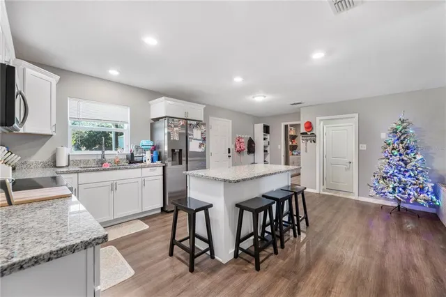 a view of a dining room kitchen with furniture and wooden floor