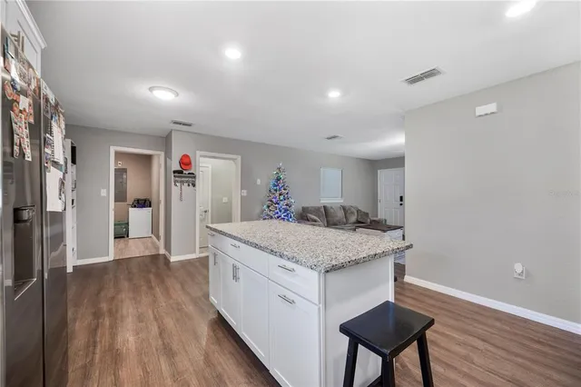 a spacious bathroom with a granite countertop sink a mirror and shower