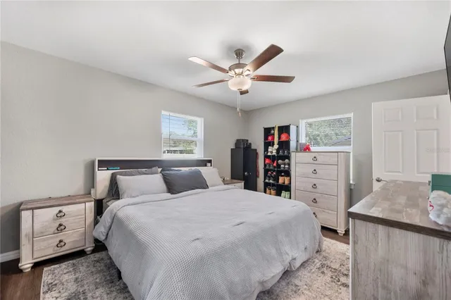 a bedroom with a large bed and a chandelier