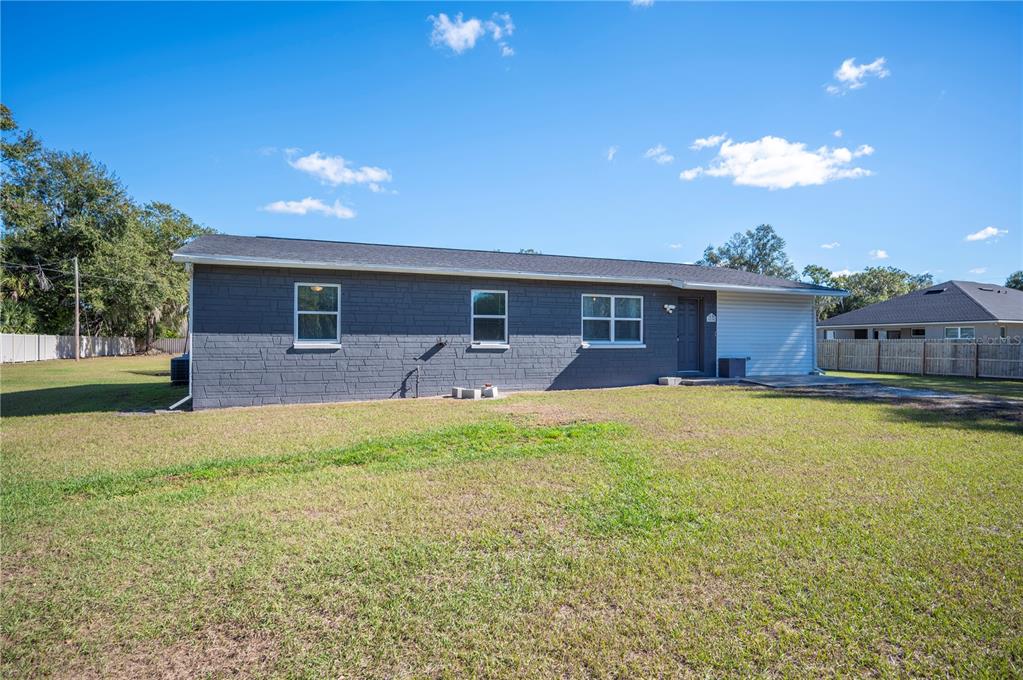 6830 County Line Road Lakeland, FL 33811 - Photo 2 of 32 a front view of house with yard and outdoor seating