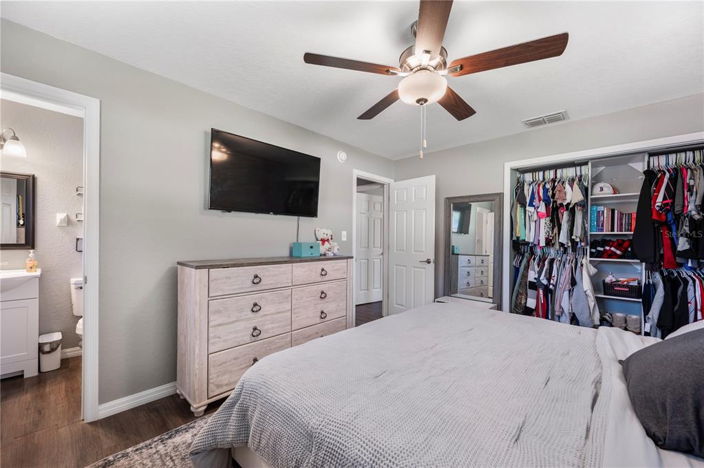 6830 County Line Road Lakeland, FL 33811 - Photo 21 of 32 a bedroom with a bed and a flat screen tv