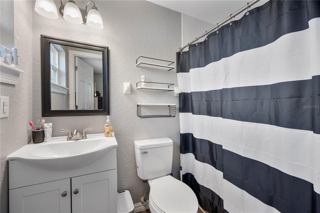 6830 County Line Road Lakeland, FL 33811 - Photo 22 of 32 a bathroom with a toilet a sink and a mirror