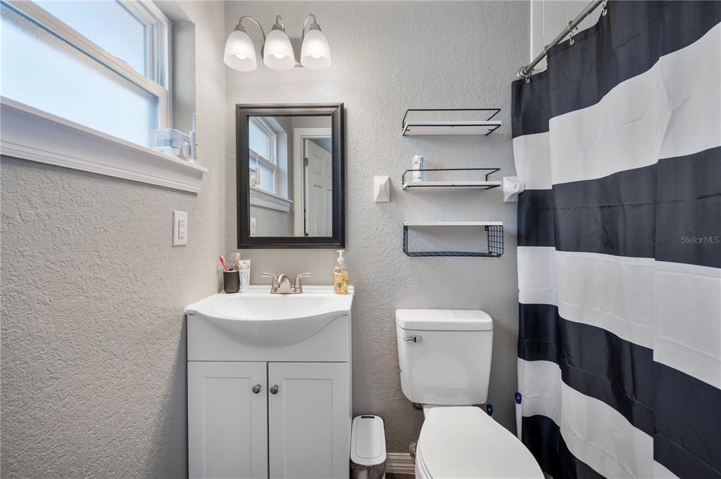 6830 County Line Road Lakeland, FL 33811 - Photo 23 of 32 a bathroom with a toilet a sink and mirror