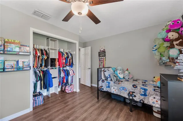 a bedroom with furniture and wooden floor