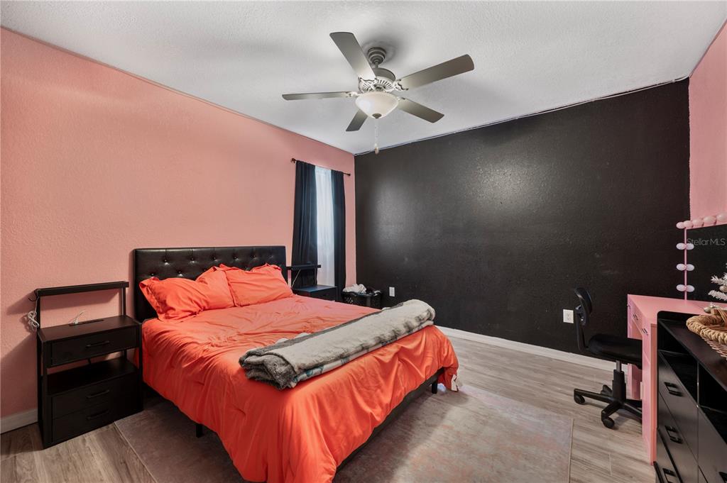 6830 County Line Road Lakeland, FL 33811 - Photo 26 of 32 a bedroom with a bed and a chandelier