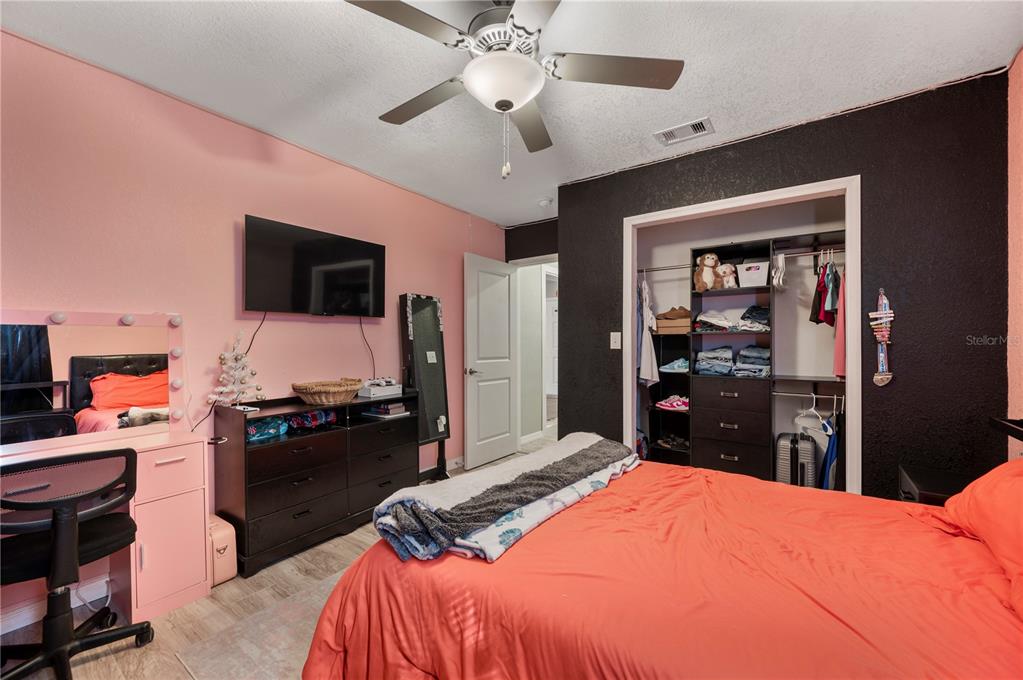 6830 County Line Road Lakeland, FL 33811 - Photo 27 of 32 a bedroom with a bed and a flat screen tv