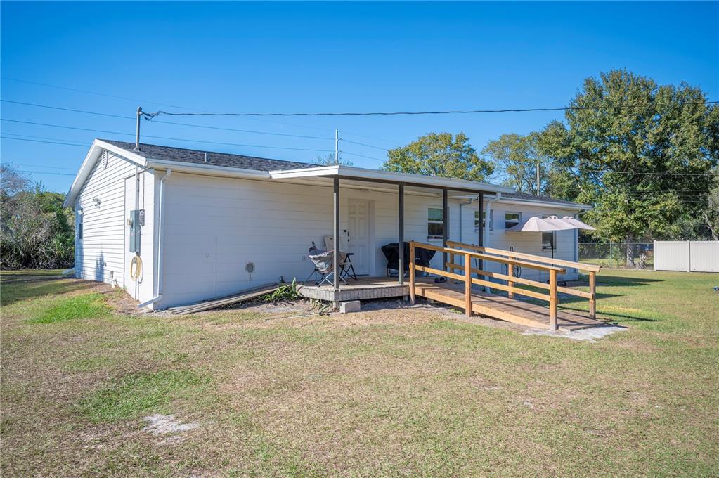 6830 County Line Road Lakeland, FL 33811 - Photo 30 of 32 front view of a house with a yard and a wooden fence