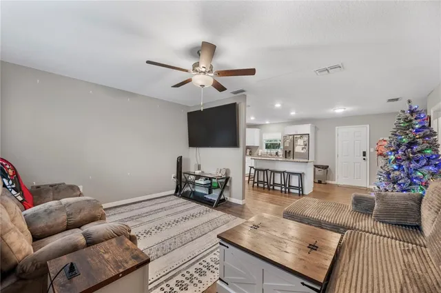 a living room with furniture and flowers