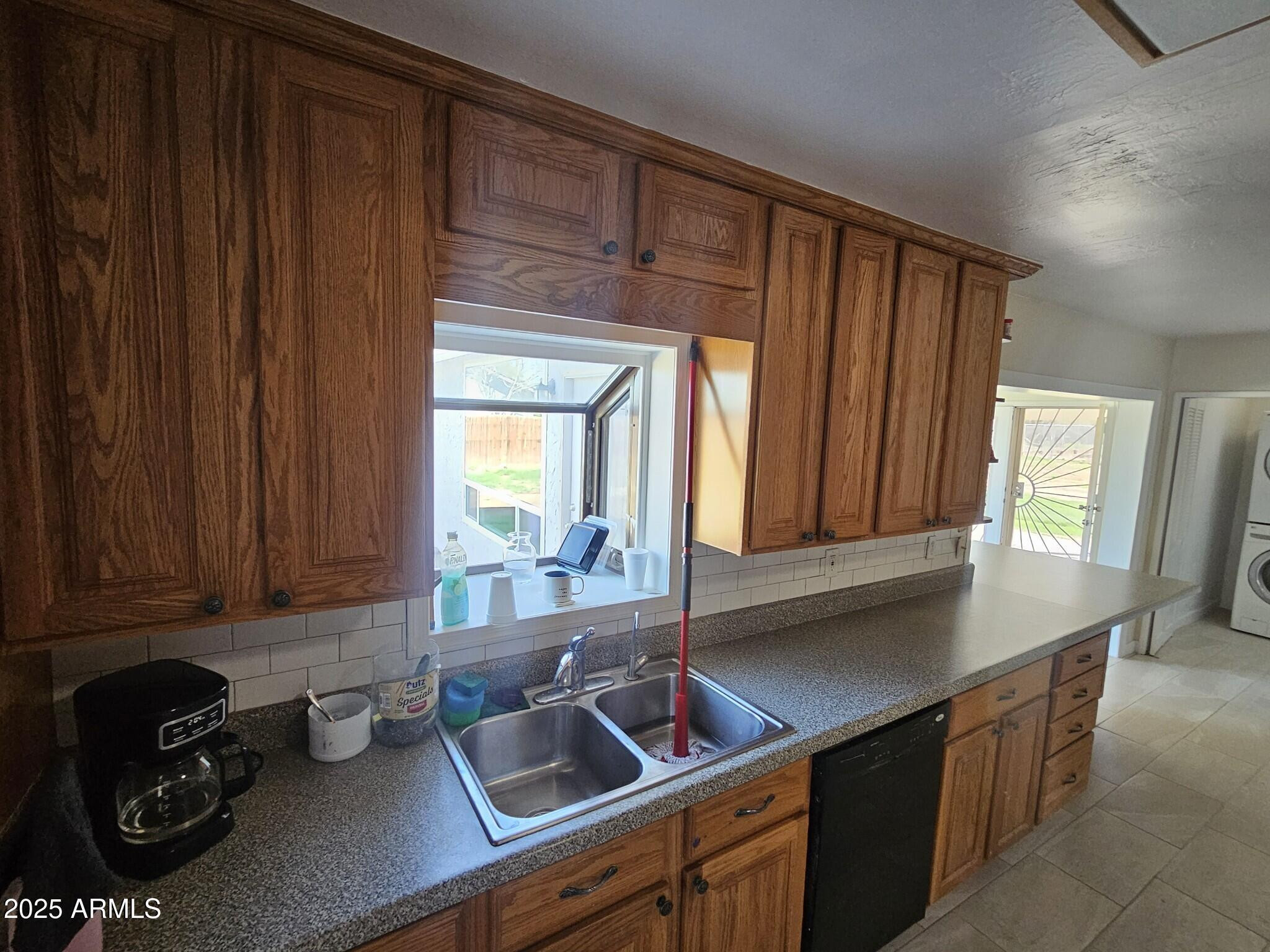 819 East Apollo Road Phoenix, AZ 85042 - Photo 5 of 17 a kitchen with a sink cabinets and a window
