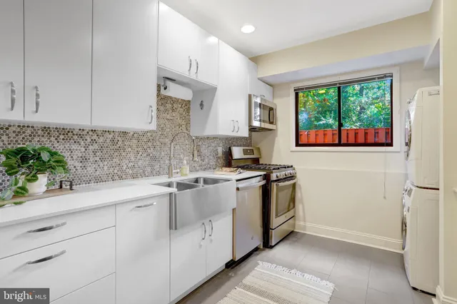 a kitchen with granite countertop white cabinets and white appliances