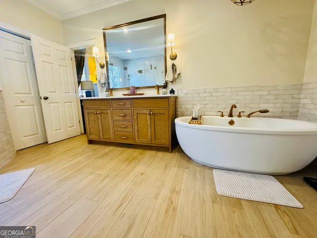 a bathroom with a tub sink toilet and shower