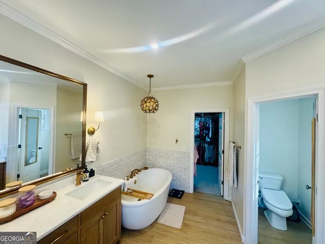a living room with furniture a flat screen tv and floor to ceiling window