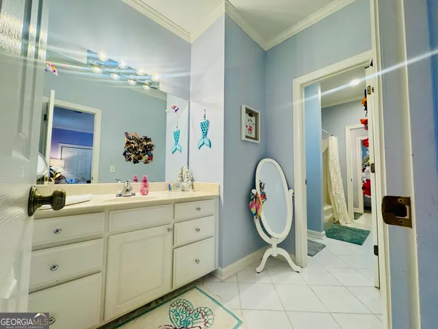 a spacious bathroom with a shower sink and mirror