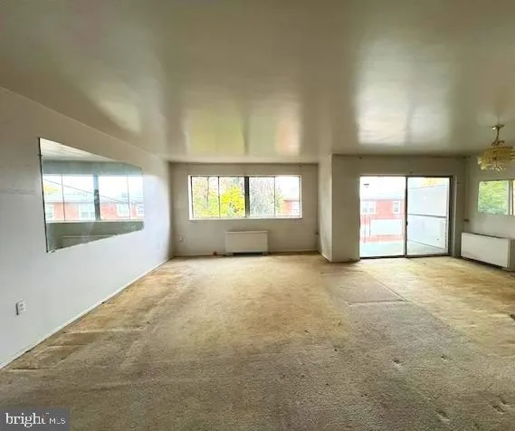 a view of empty room with a fireplace