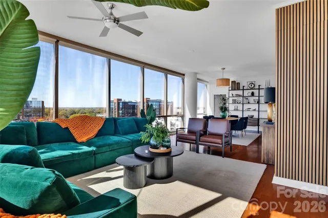 a living room with patio furniture and a potted plant
