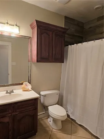 a bathroom with a sink vanity mirror and toilet