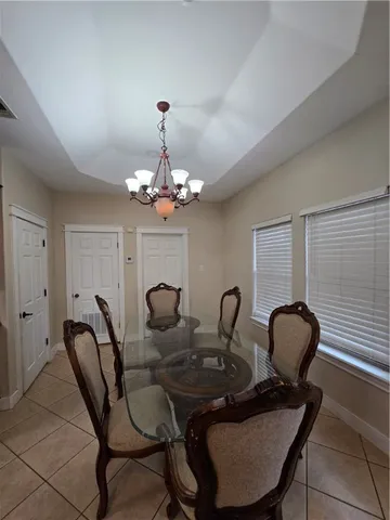 a view of a dining room with furniture and chandelier