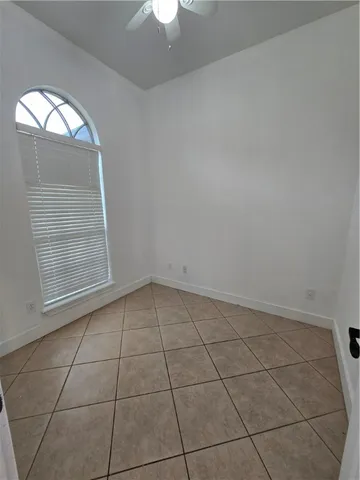 an empty room with a empty space and windows