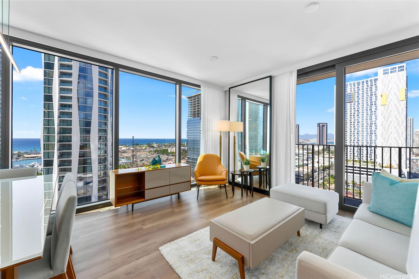 987 Queen Street, Unit 1701 Honolulu, HI 96814 - Photo 1 of 1 a living room with furniture and a large window