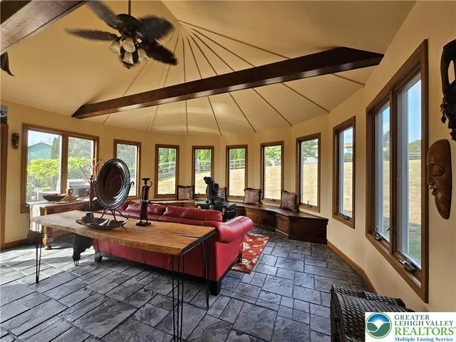 a living room with furniture a rug and a chandelier