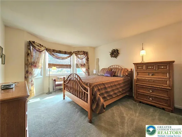 a bedroom with a bed and a table