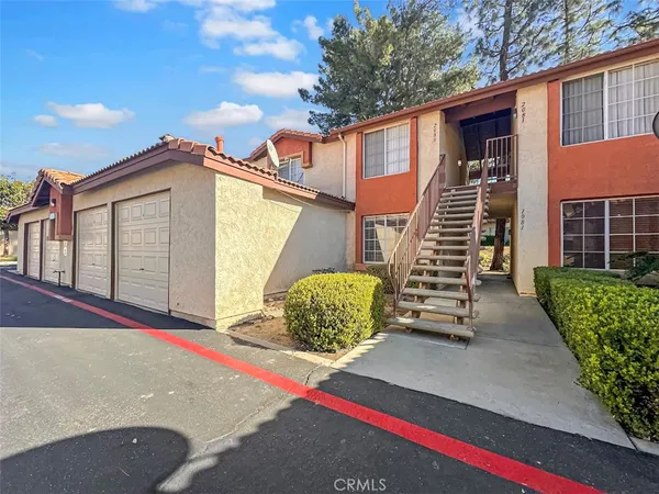 a backyard of a house with outdoor seating