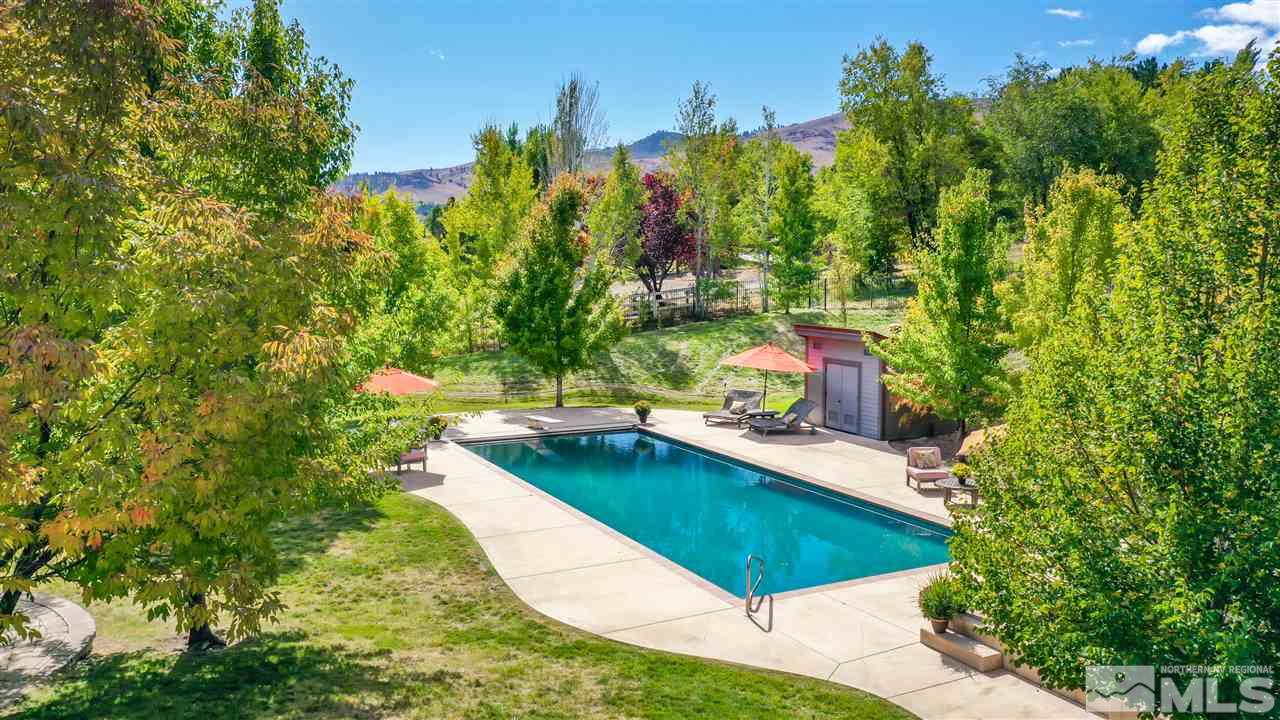 425 Juniper Hill Road Reno, NV 89519 - Photo 4 of 15 view of a swimming pool with an outdoor seating and trees in the background