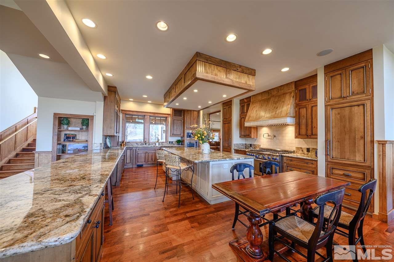 425 Juniper Hill Road Reno, NV 89519 - Photo 10 of 15 a dining hall with stainless steel appliances granite countertop a stove dining table and chairs with the granite countertops