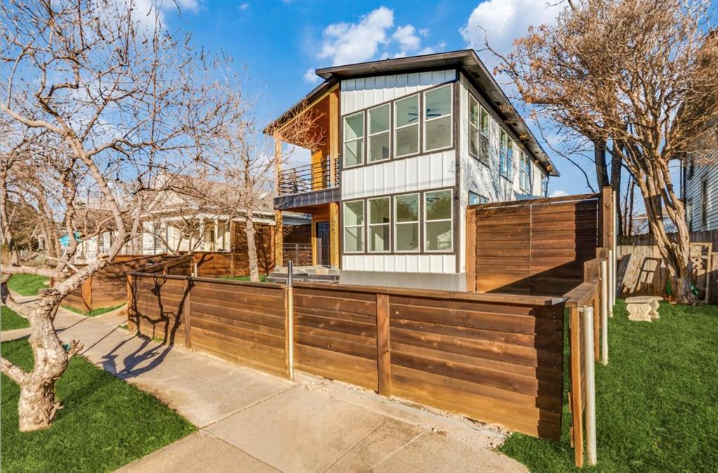 805 West 9th Street Dallas, TX 75208 - Photo 1 of 1 Contemporary two-story residence featuring white vertical siding and extensive window placements