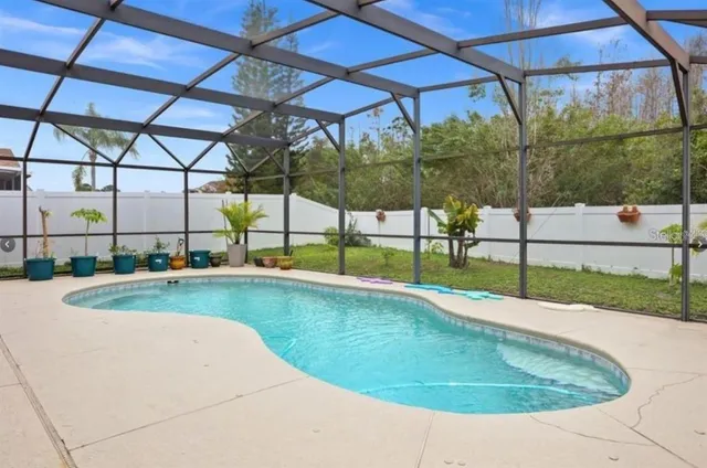 a view of a backyard with a swimming pool
